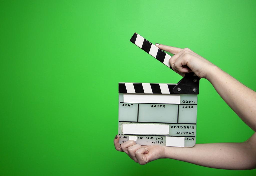 Film director on set looking at a monitor