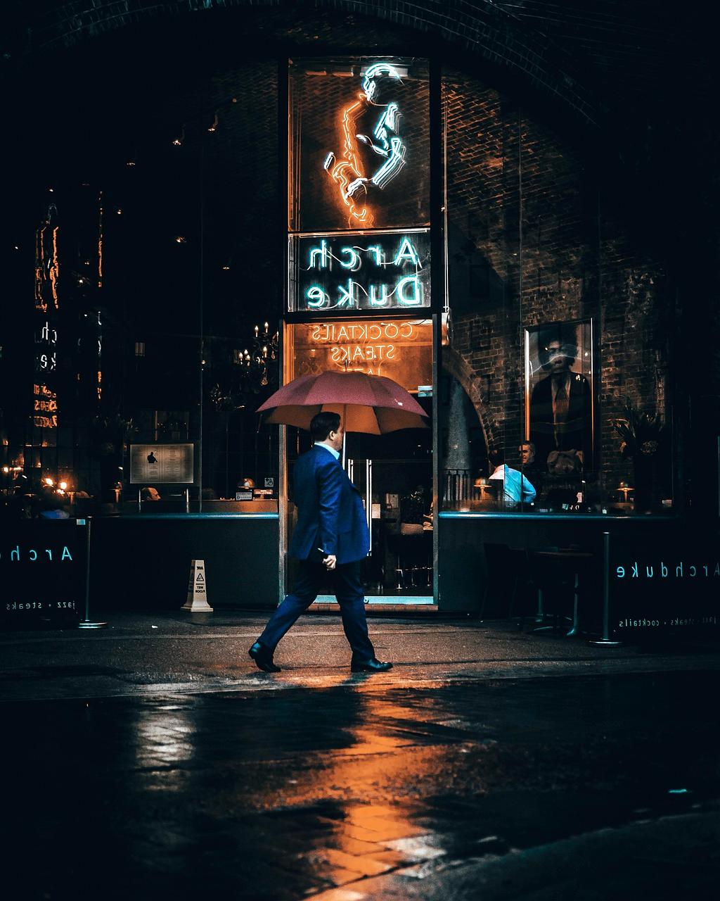 Movie poster featuring a detective standing in the rain